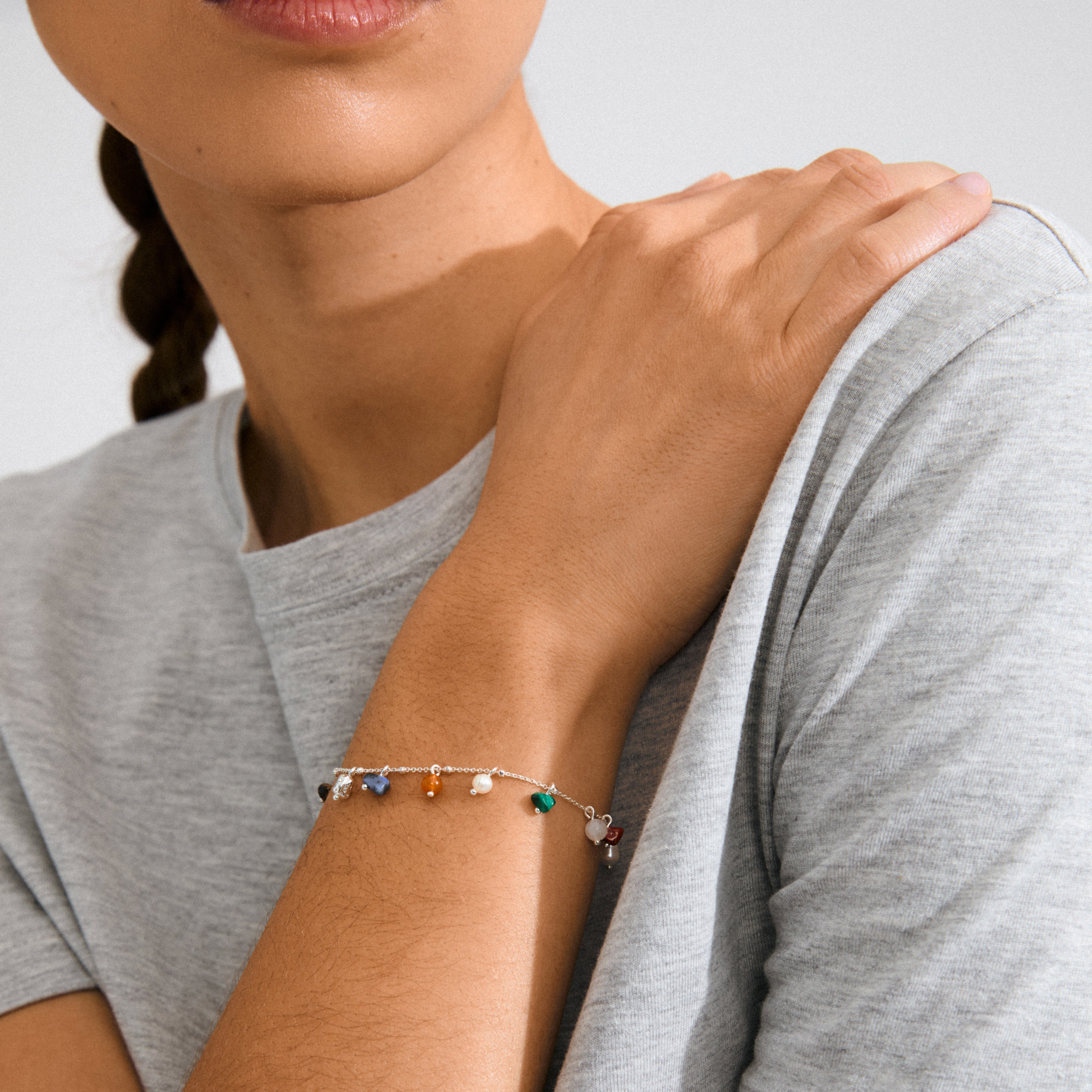 Person wearing the BETWEEN bracelet, silver-plated with semi-precious stones, showcasing Pilgrim's luxe boho style. Perfect for a unique, laid-back look.