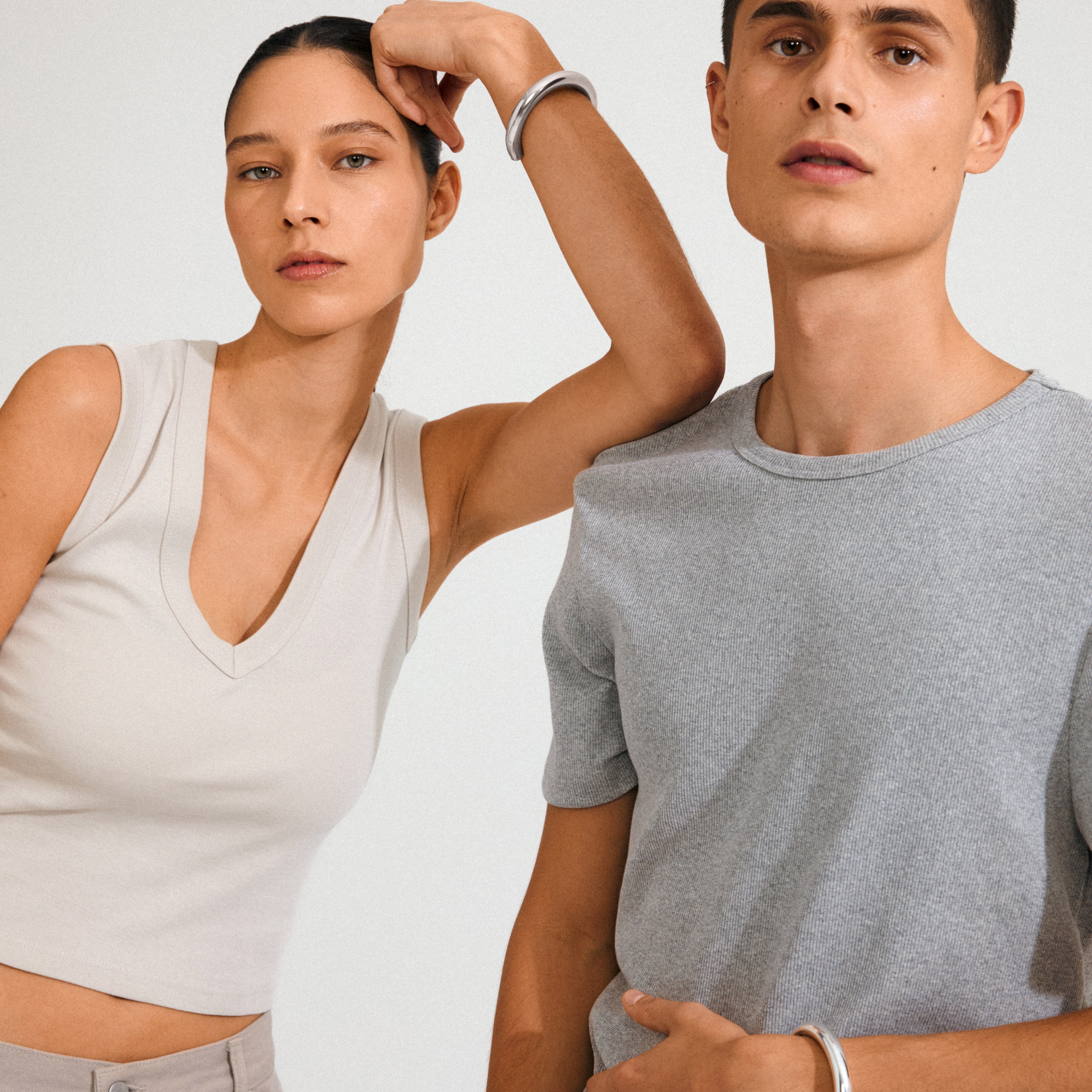 Models wearing Pilgrim's PHASE bangle silver-plated, showcasing minimalist, shiny silver bracelets, embodying trendy, Scandinavian-inspired style and sustainability.