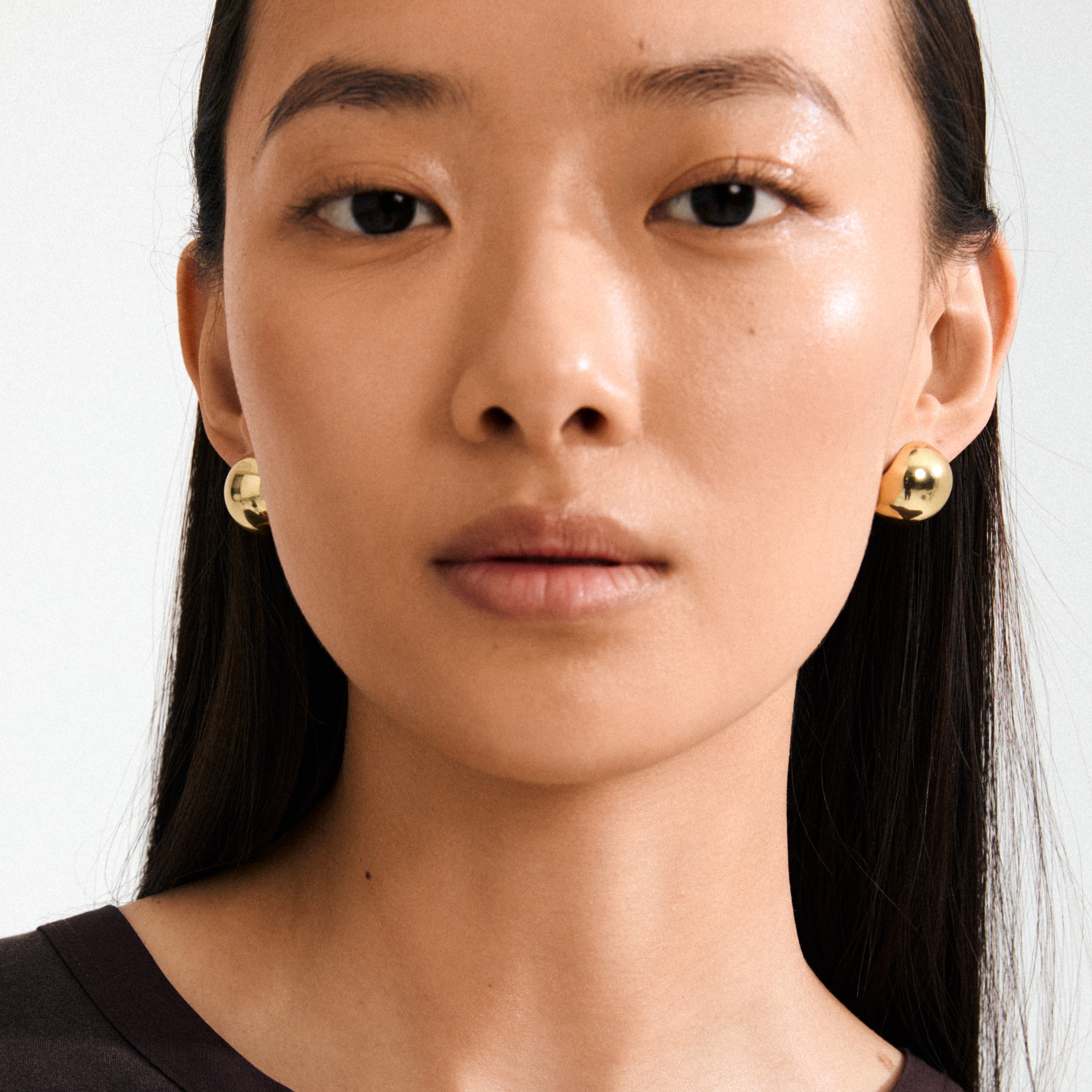Woman wearing Pilgrim's JACE gold-plated bubble dome earrings, showcasing a vintage-inspired, stylish design perfect for everyday wear.