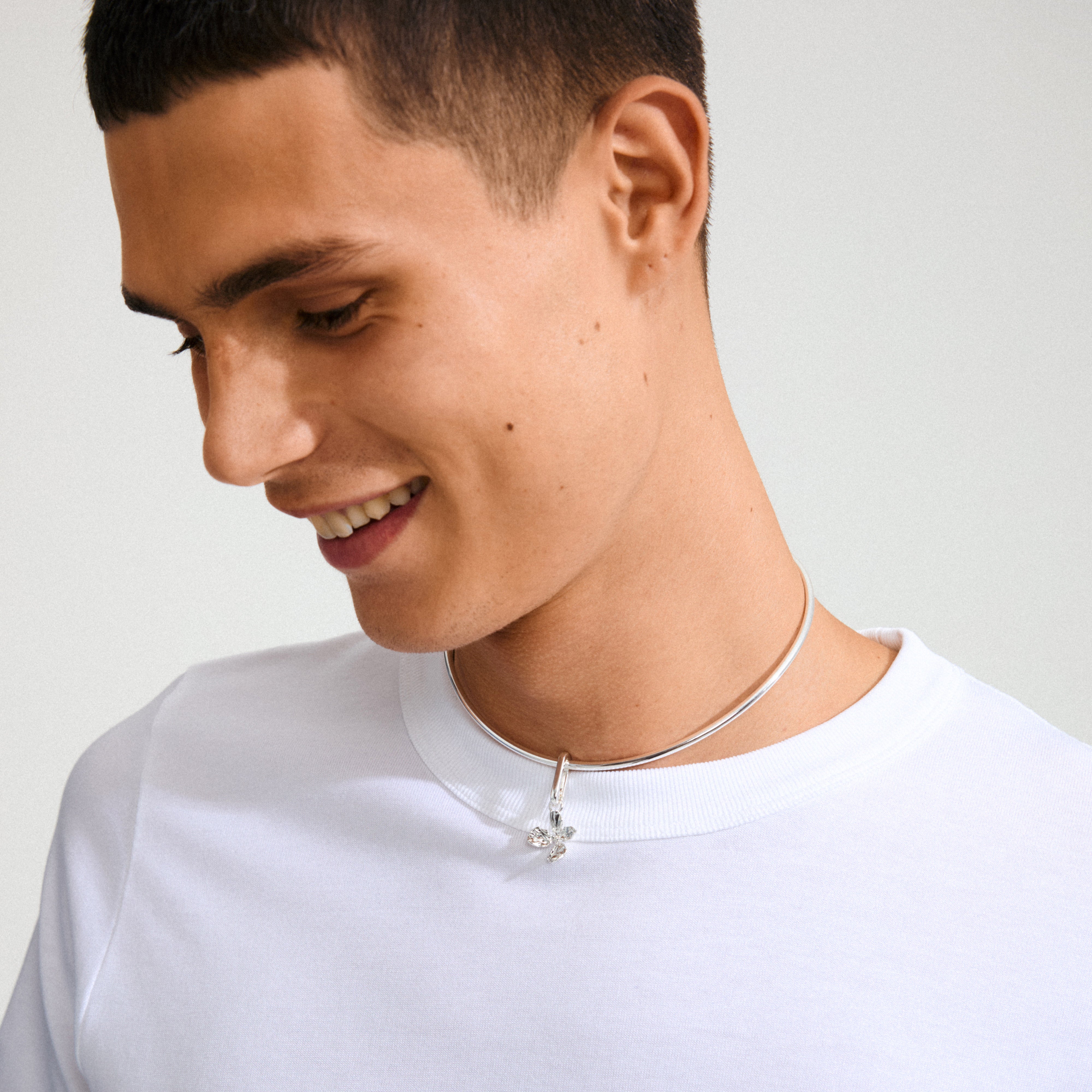 Model wearing Pilgrim's CHARM flower pendant, silver-plated, showcasing a boho flower motif on a slim choker necklace.